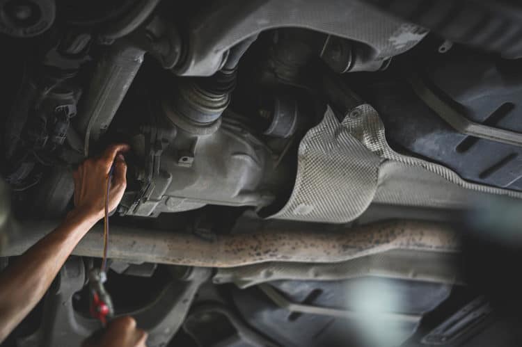 Dana 44A Strength Auto Mechanic Filling car rear differential fluid.